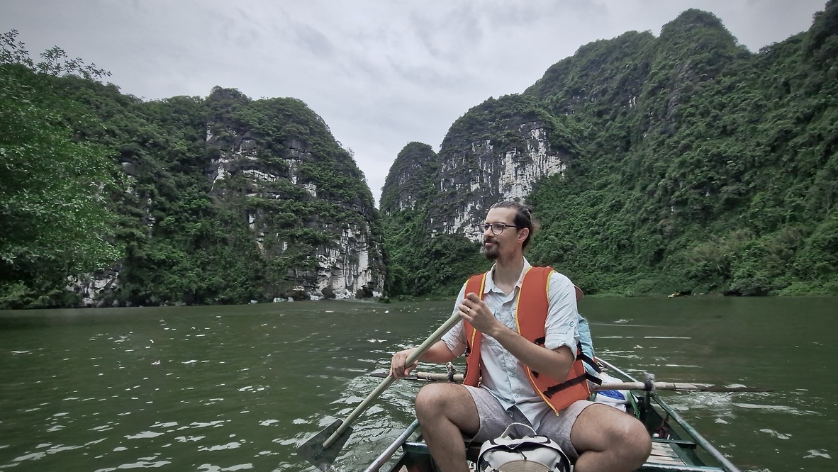 Rowing a boat between limestone karsts
